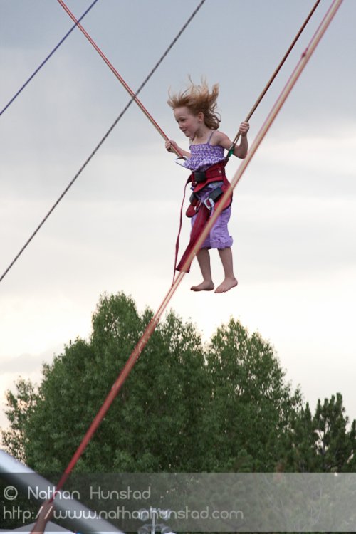 A kid having fun on the bungee jump at the Colorado Irish Festival